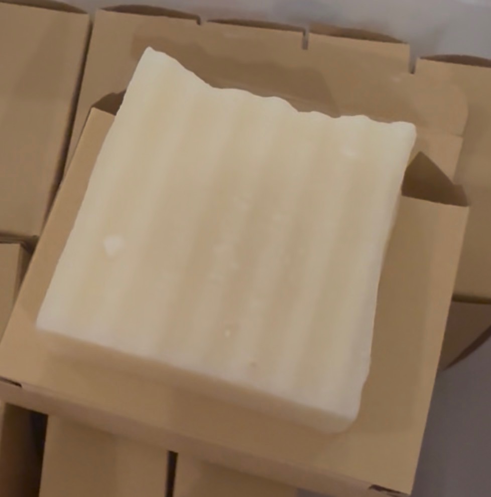 Handmade creamy tallow soap bar in kraft packaging
